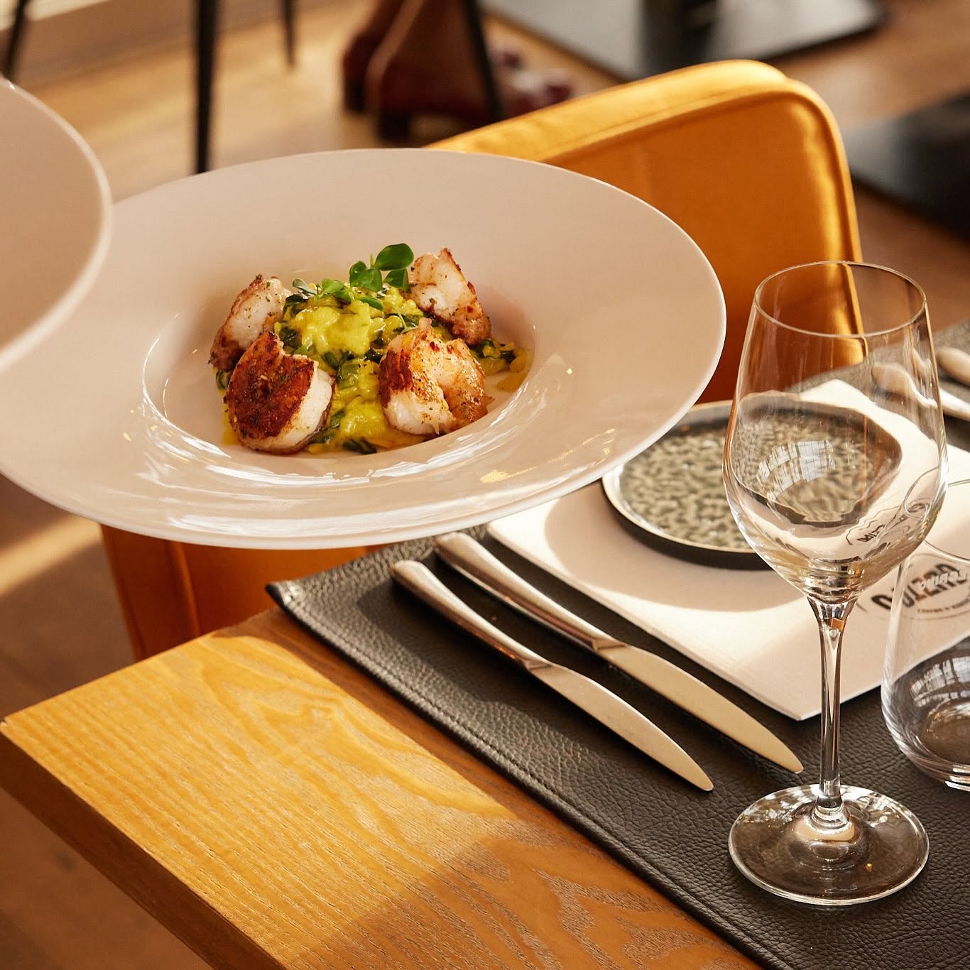 restaurant table dish with fish being plated